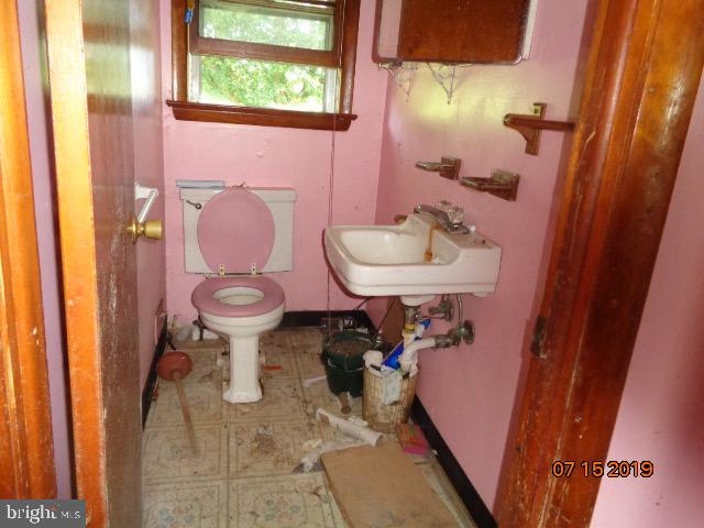 17 Tilbury Road Salem, NJ 08079 - Photo 11 of 17 a bathroom with a sink toilet and a mirror