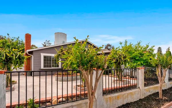 a view of a house with a yard and plants