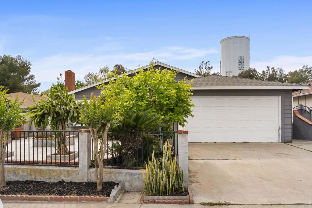 1850 Paradise Hills Road San Diego, CA 92114 - Photo 2 of 39 a view of a house with a yard and plants