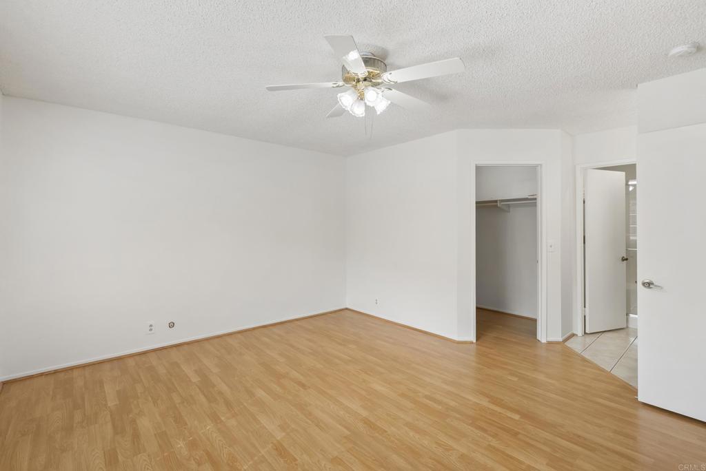 1850 Paradise Hills Road San Diego, CA 92114 - Photo 22 of 39 a view of a room with wooden floor and a ceiling fan