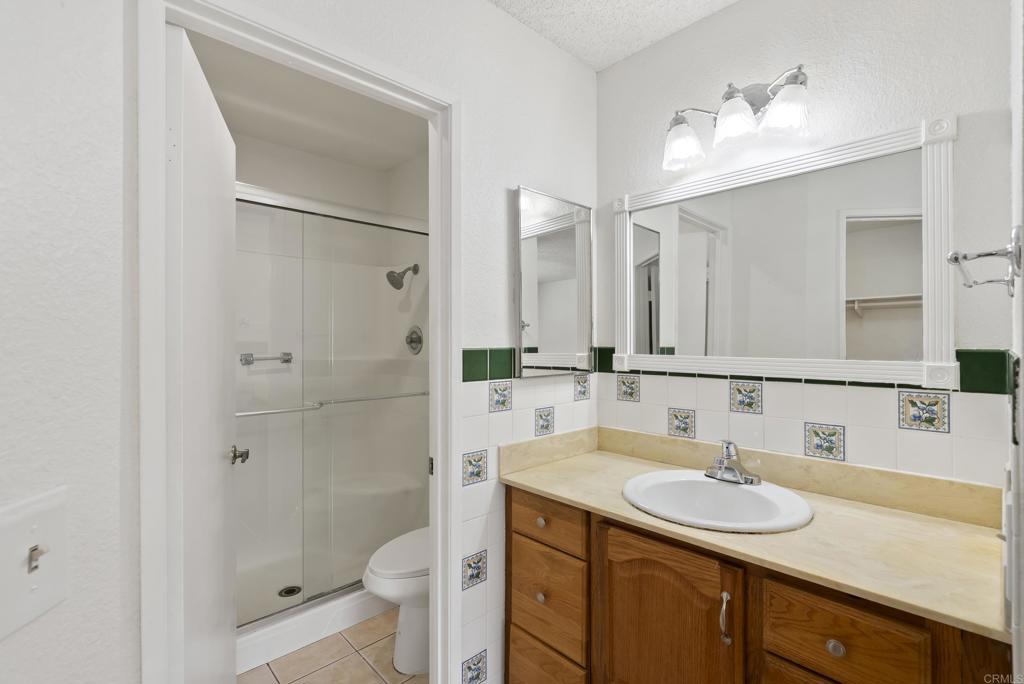1850 Paradise Hills Road San Diego, CA 92114 - Photo 25 of 39 a bathroom with a sink and a mirror