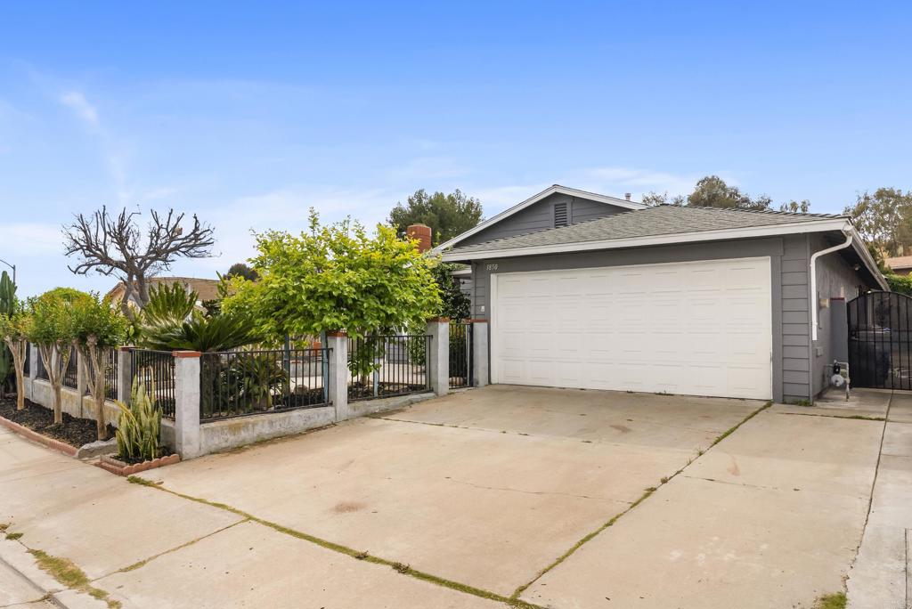 1850 Paradise Hills Road San Diego, CA 92114 - Photo 3 of 39 a front view of a house with a garden