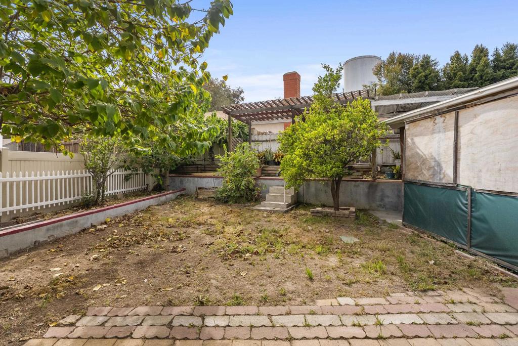 1850 Paradise Hills Road San Diego, CA 92114 - Photo 37 of 39 a backyard of a house with lots of green space