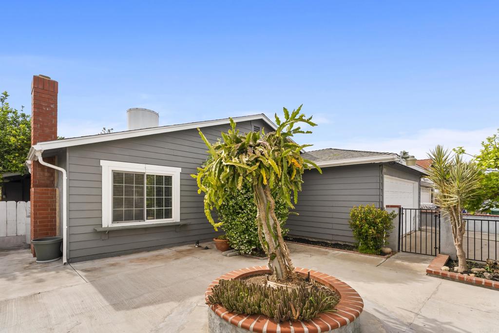 1850 Paradise Hills Road San Diego, CA 92114 - Photo 6 of 39 a front view of a house with garden
