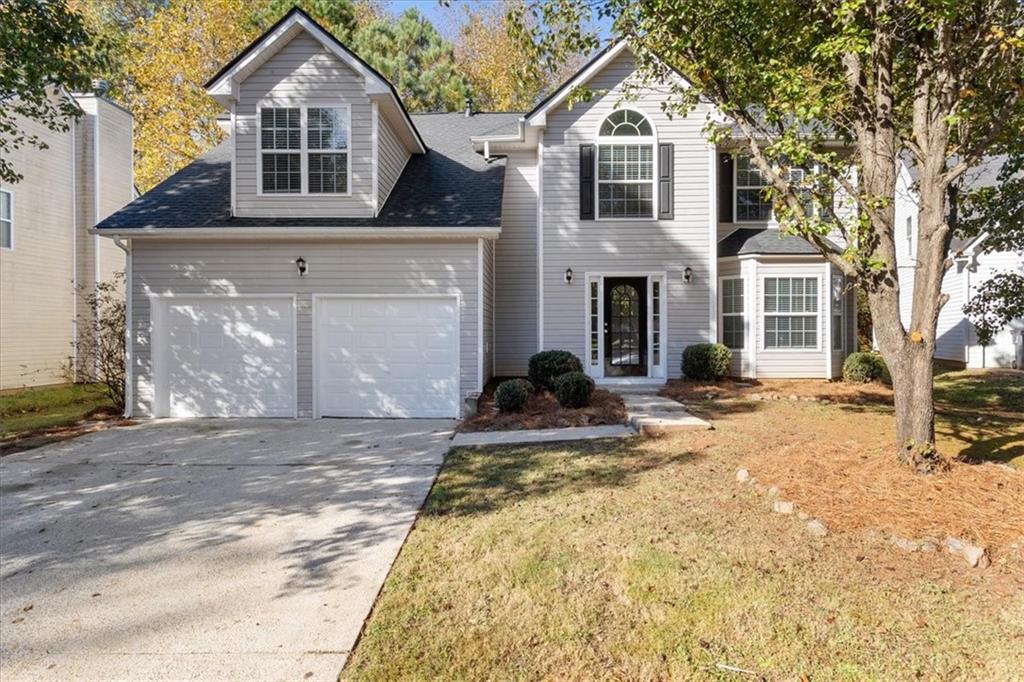 2041 Reflective Waters Road Villa Rica, GA 30180 - Photo 1 of 1 a front view of a house with a yard