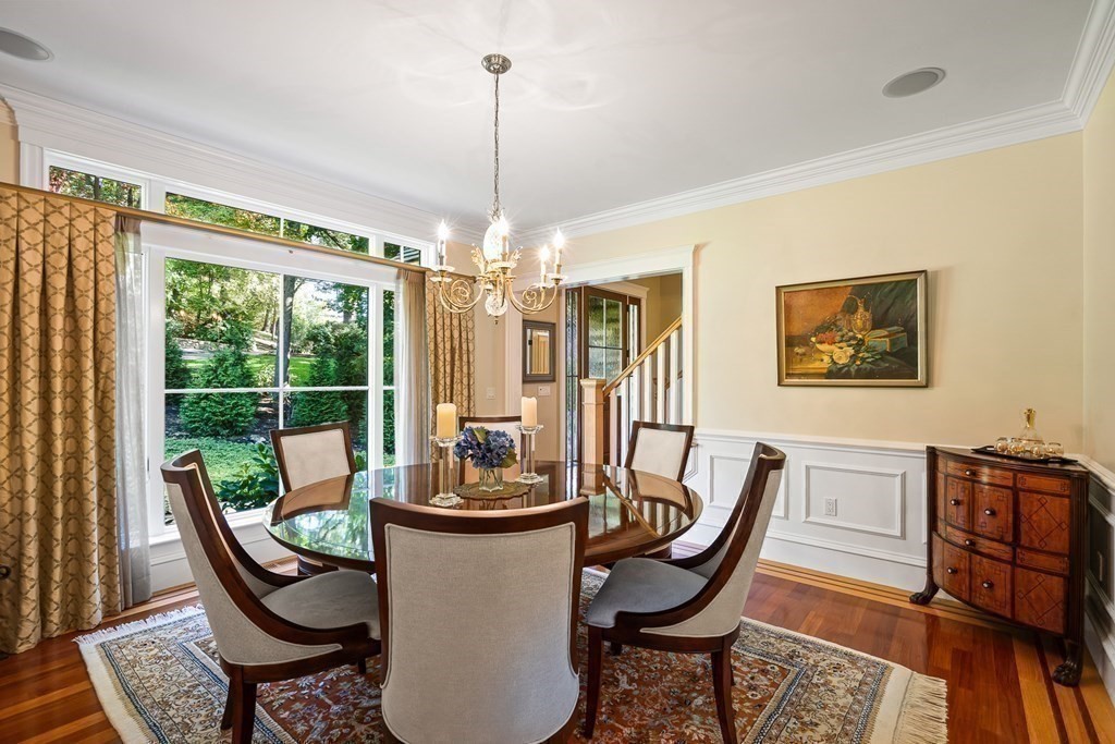 22 McCall Road Winchester, MA 01890 - Photo 18 of 40 a view of a dining room with furniture wooden floor and a chandelier