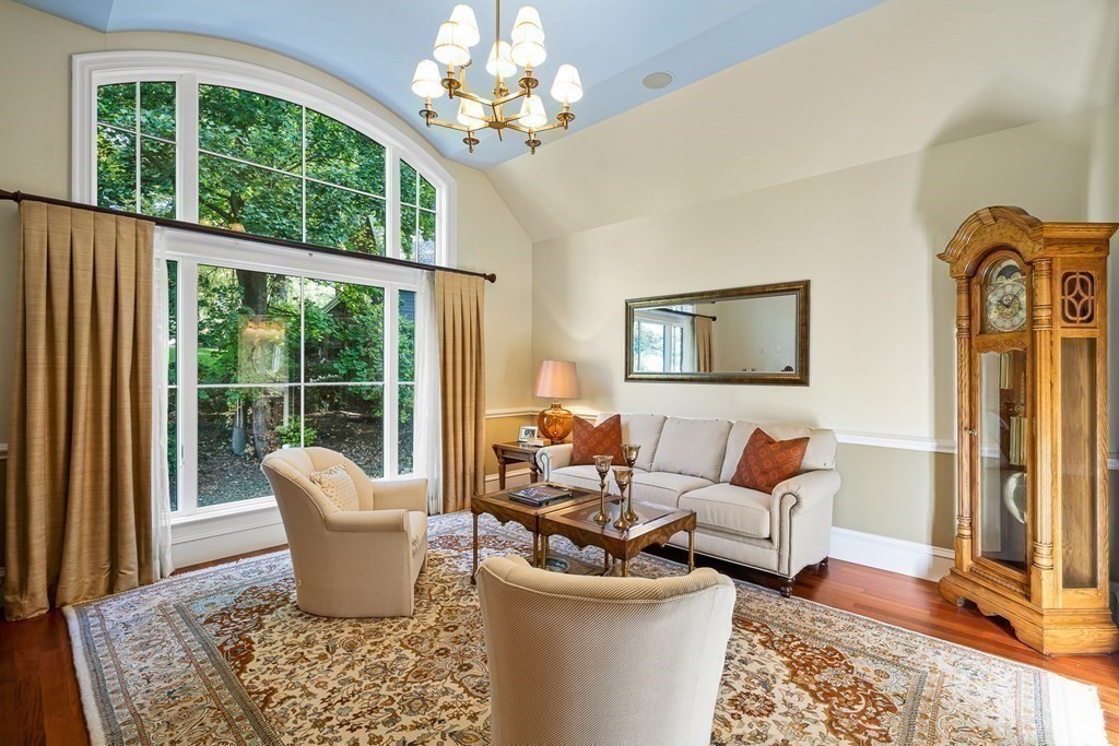 22 McCall Road Winchester, MA 01890 - Photo 19 of 40 a living room with furniture a chandelier and a large window