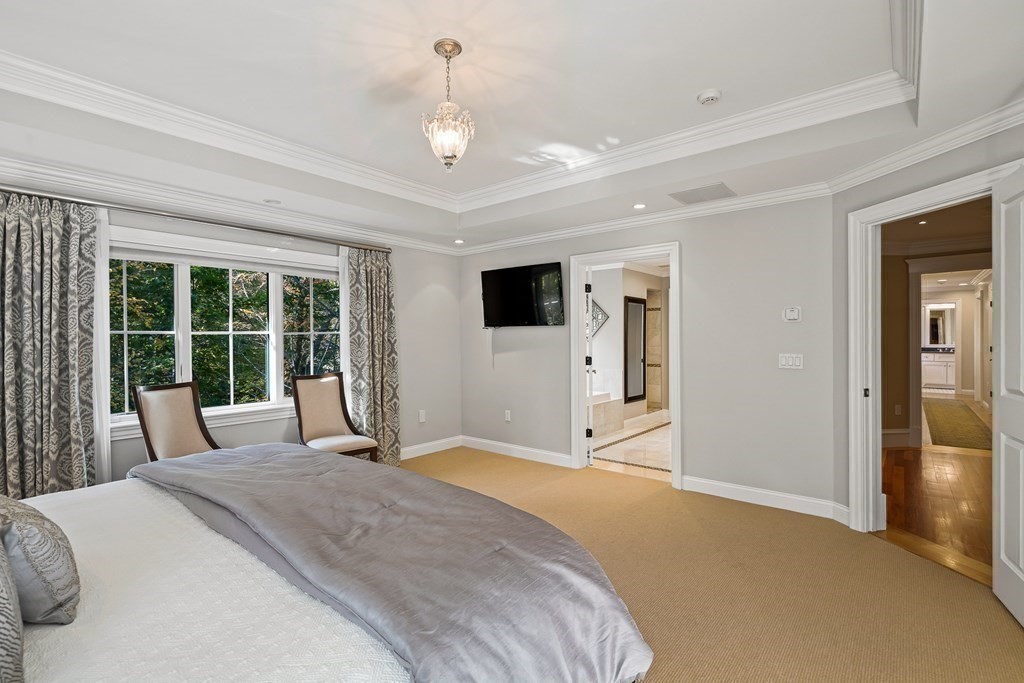 22 McCall Road Winchester, MA 01890 - Photo 22 of 40 a bedroom with a large bed and a large window