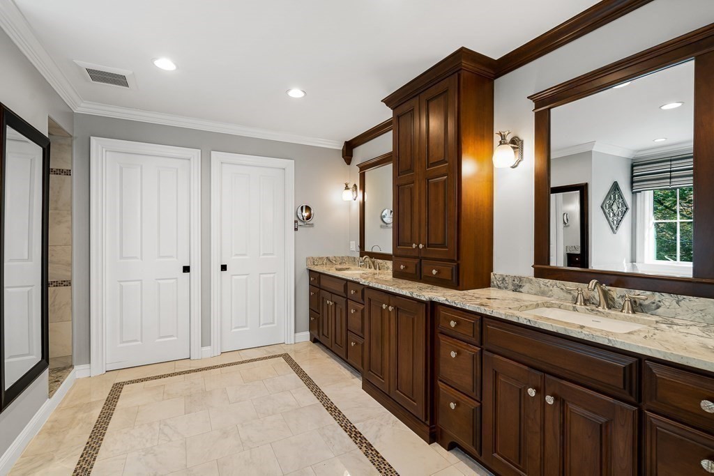 22 McCall Road Winchester, MA 01890 - Photo 23 of 40 a spacious bathroom with a double vanity sink and a mirror