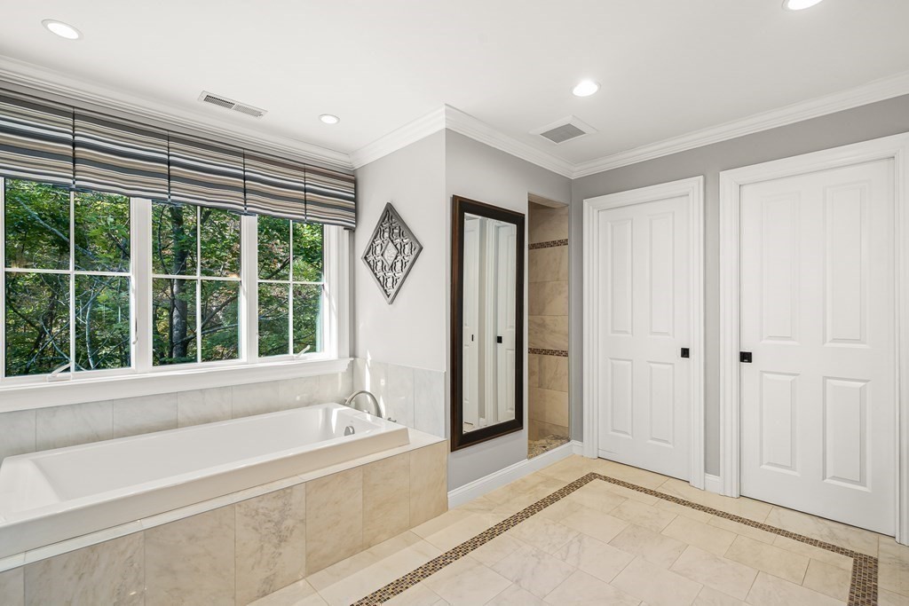 22 McCall Road Winchester, MA 01890 - Photo 24 of 40 a spacious bathroom with a bathtub and a large window