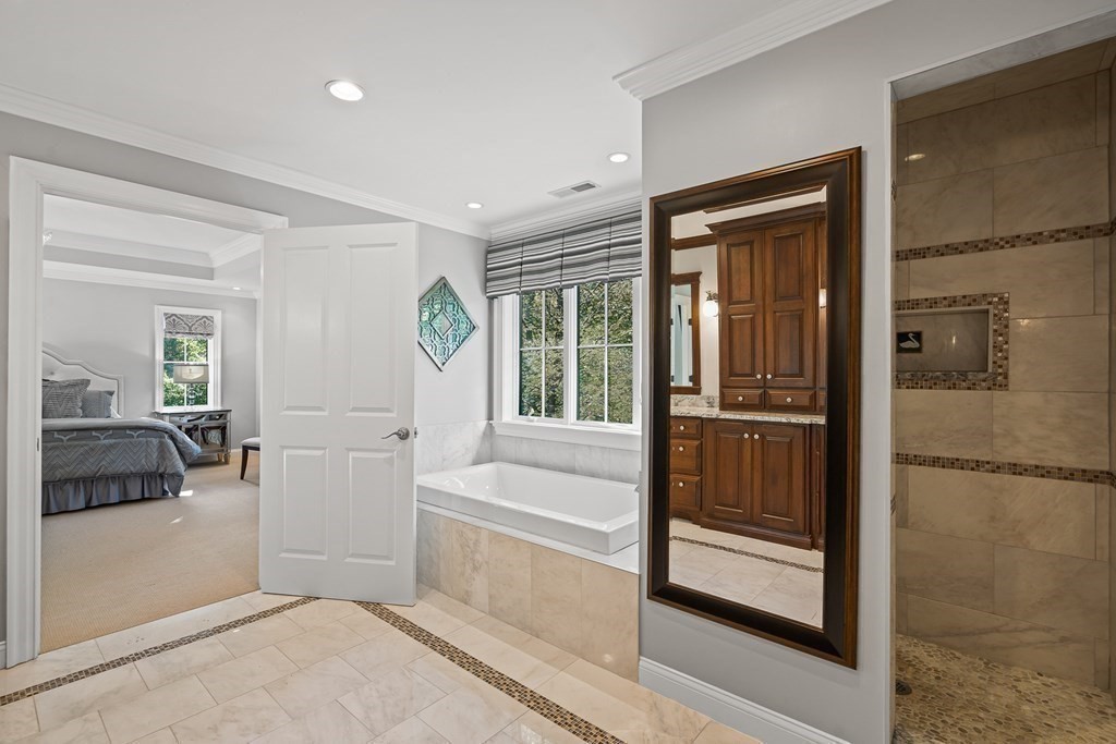 22 McCall Road Winchester, MA 01890 - Photo 25 of 40 a bathroom with a tub and shower