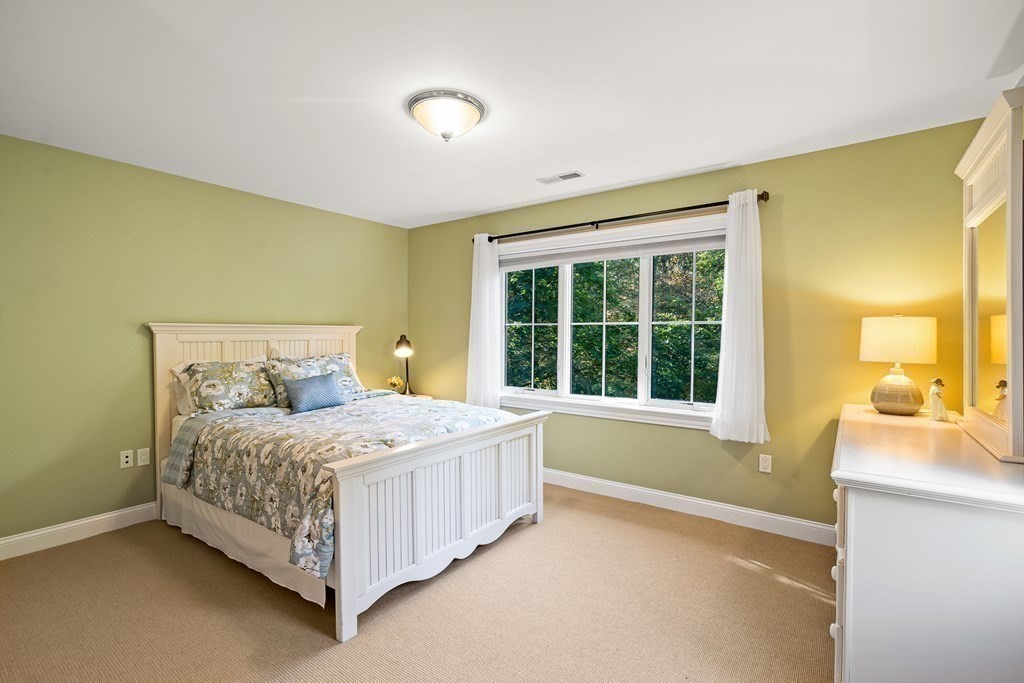 22 McCall Road Winchester, MA 01890 - Photo 28 of 40 a bedroom with a bed lamp and a large window