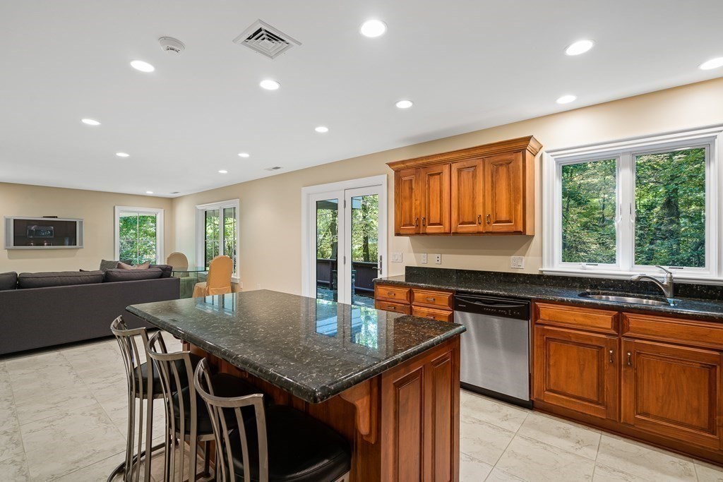 22 McCall Road Winchester, MA 01890 - Photo 31 of 40 a kitchen with granite countertop lots of counter space dining table and chairs