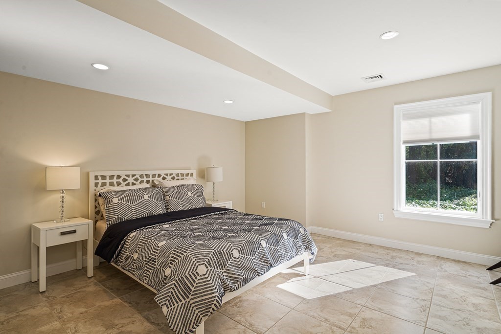 22 McCall Road Winchester, MA 01890 - Photo 32 of 40 a bedroom with a large bed and a window