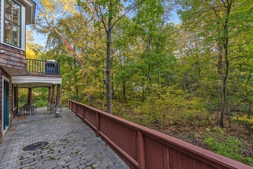 22 McCall Road Winchester, MA 01890 - Photo 33 of 40 a view of a wooden balcony with a trees