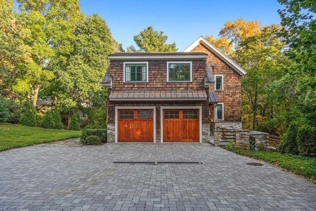 22 McCall Road Winchester, MA 01890 - Photo 6 of 40 a front view of a house with a yard and garage