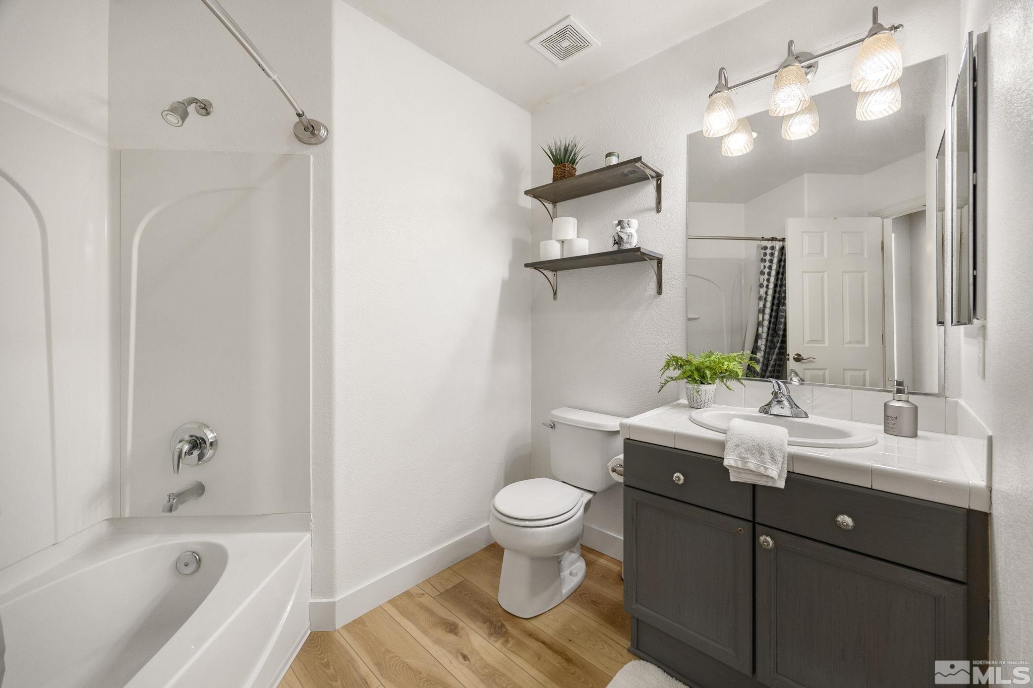 224 Bartmess Boulevard Sparks, NV 89436 - Photo 8 of 20 a bathroom with a sink a toilet and shower
