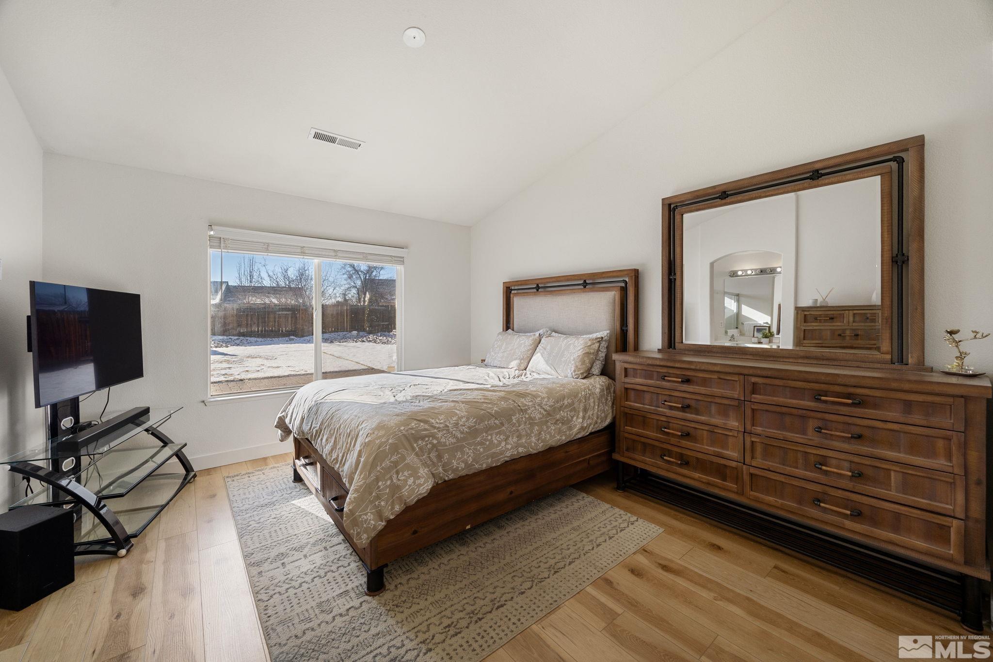 224 Bartmess Boulevard Sparks, NV 89436 - Photo 9 of 20 a bedroom with a bed and a flat tv screen on dresser