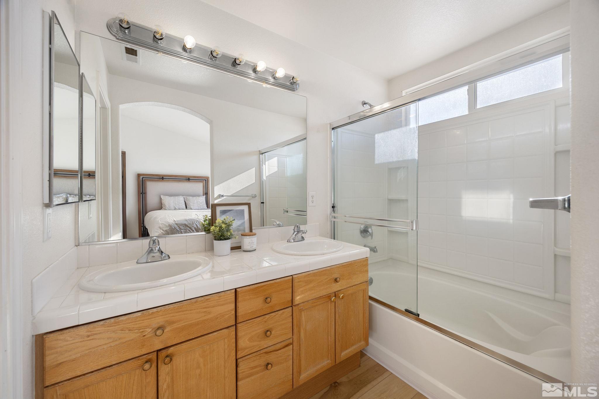 224 Bartmess Boulevard Sparks, NV 89436 - Photo 10 of 20 a bathroom with a double vanity sink mirror double and shower