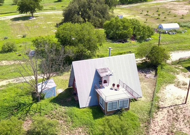 a view of a house with pool and a yard