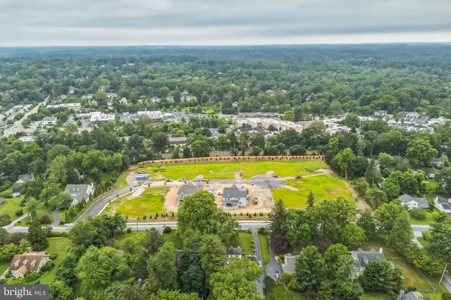 an aerial view of residential houses with swimming pool and outdoor space