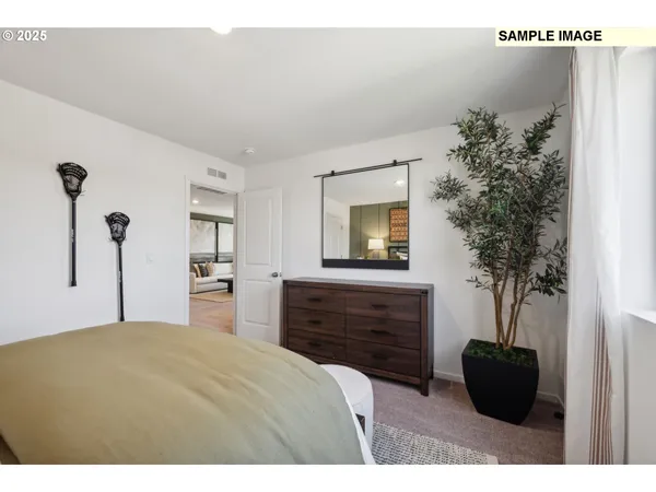 a bedroom with a bed and a potted plant