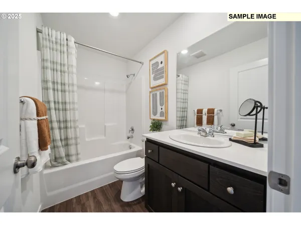 a bathroom with a sink toilet double vanity and shower
