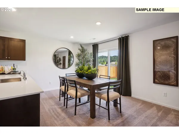 a view of a dining room with furniture and window