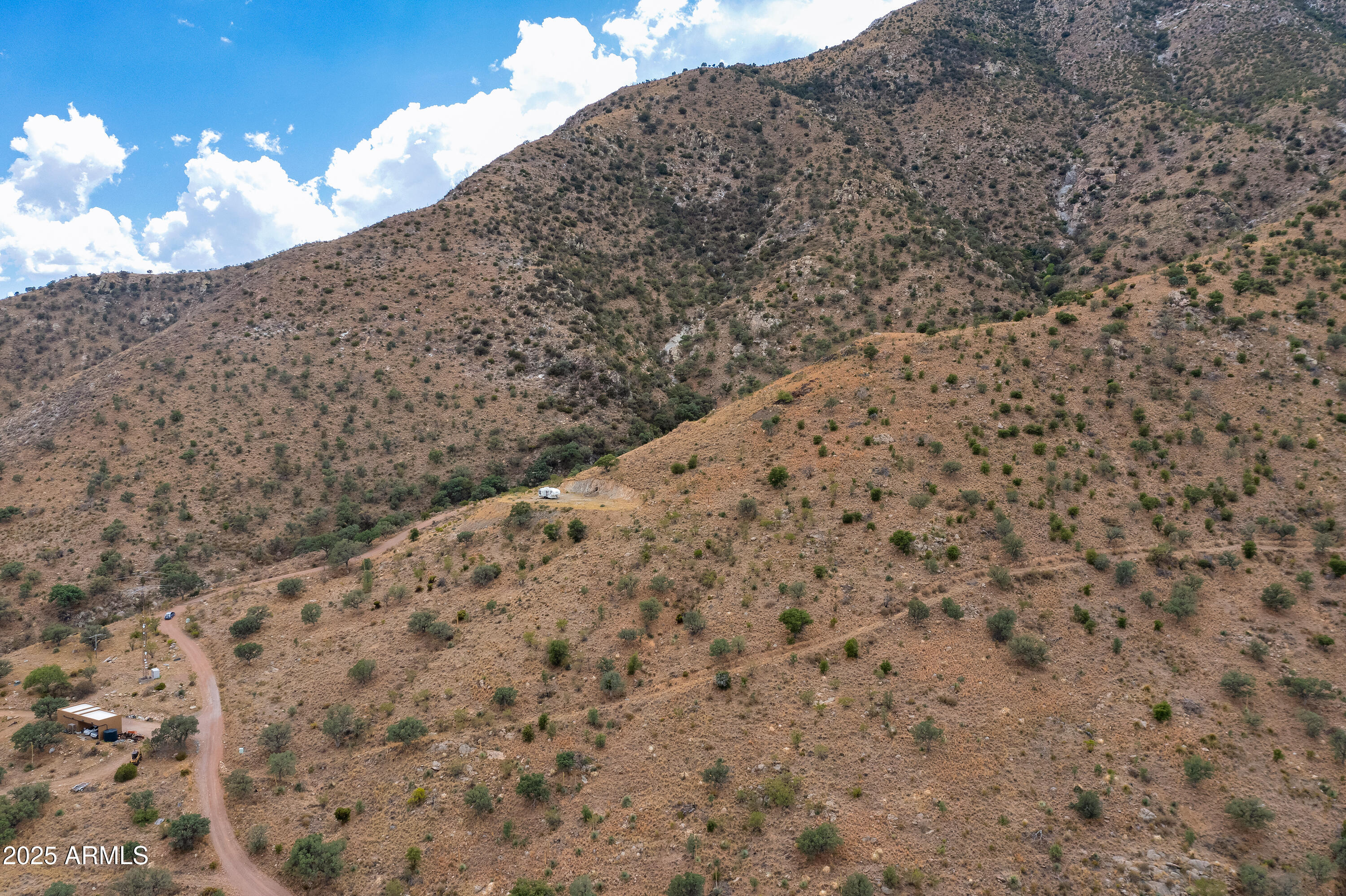 1-mm South Stone Ridge Road, Unit A Hereford, AZ 85615 - Photo 4 of 12 a view of a dry yard with mountains and bushes
