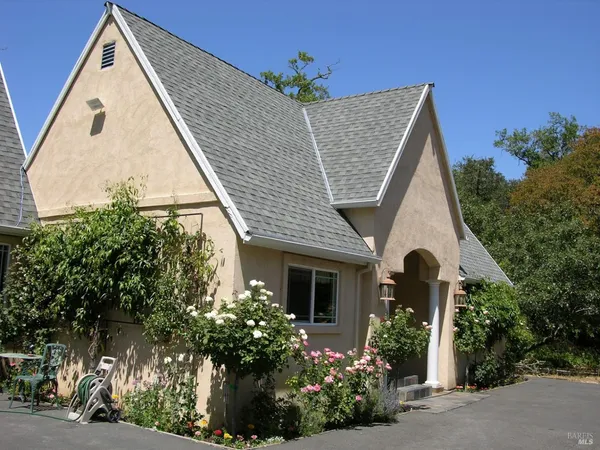 a front view of a house with garden