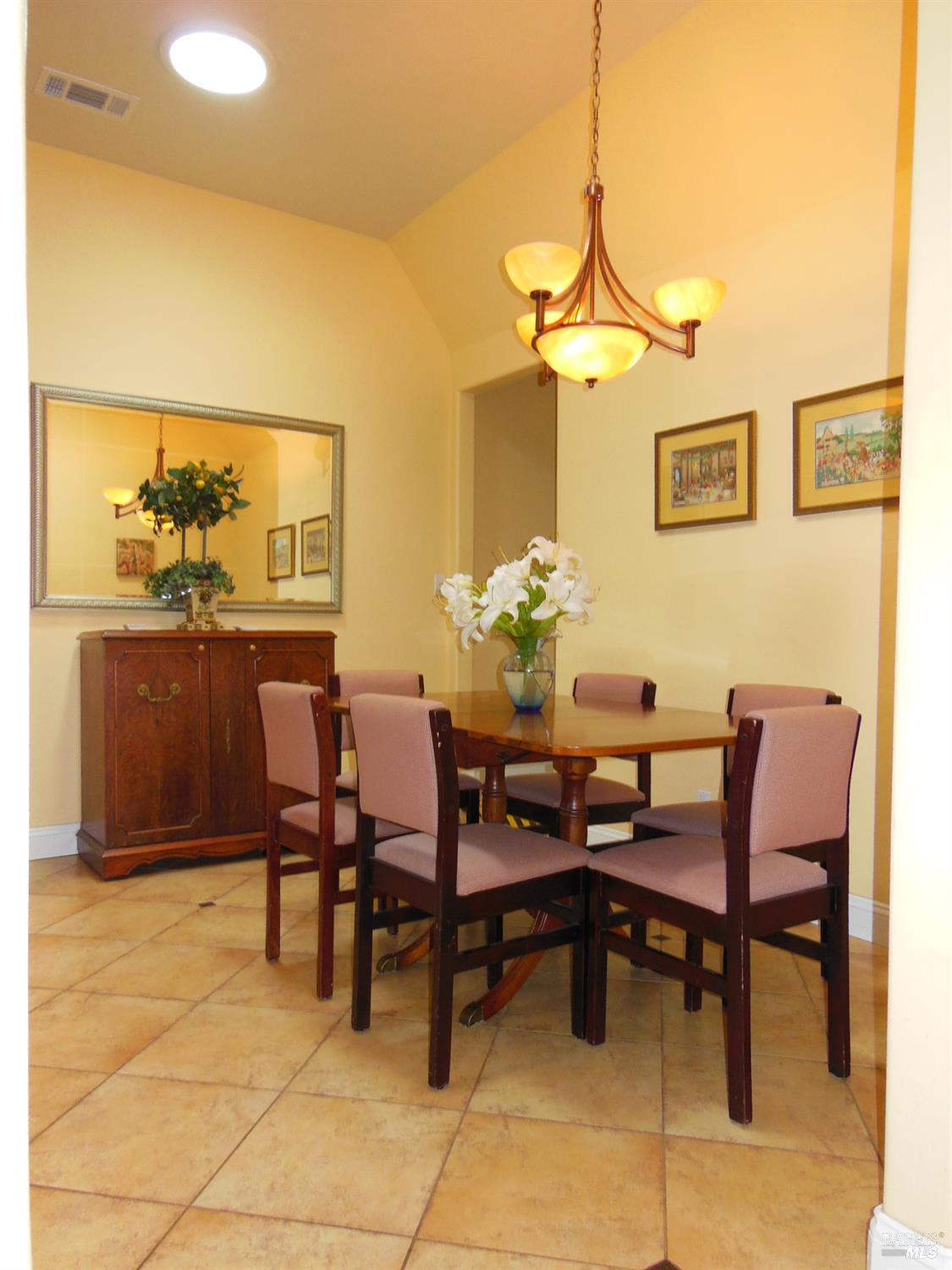 3093 Old Lawley Toll Road Calistoga, CA 94515 - Photo 5 of 17 a dining room with furniture and a chandelier