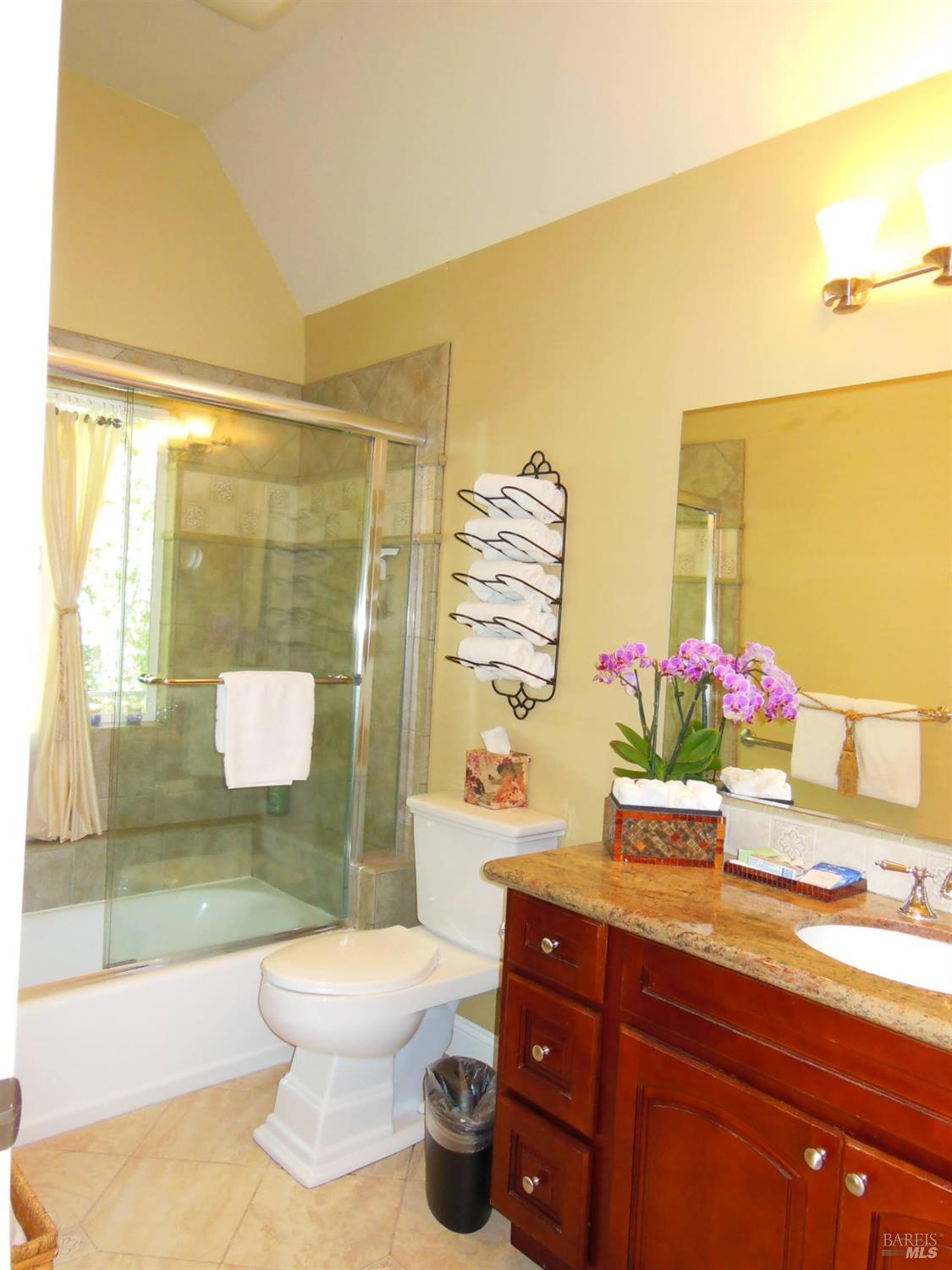3093 Old Lawley Toll Road Calistoga, CA 94515 - Photo 10 of 17 a bathroom with a granite countertop sink mirror vanity and toilet