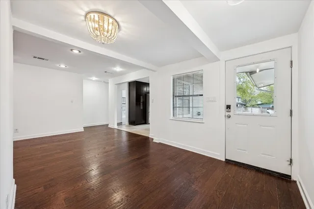 a front view of a house with a garden and yard