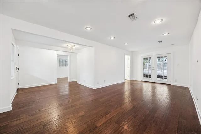 a bathroom with a double vanity sink a toilet a mirror and shower