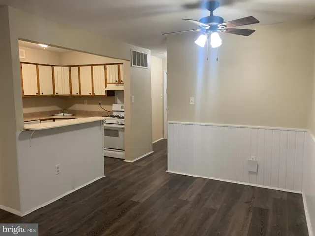 a view of a kitchen with a sink cabinets and wooden floor
