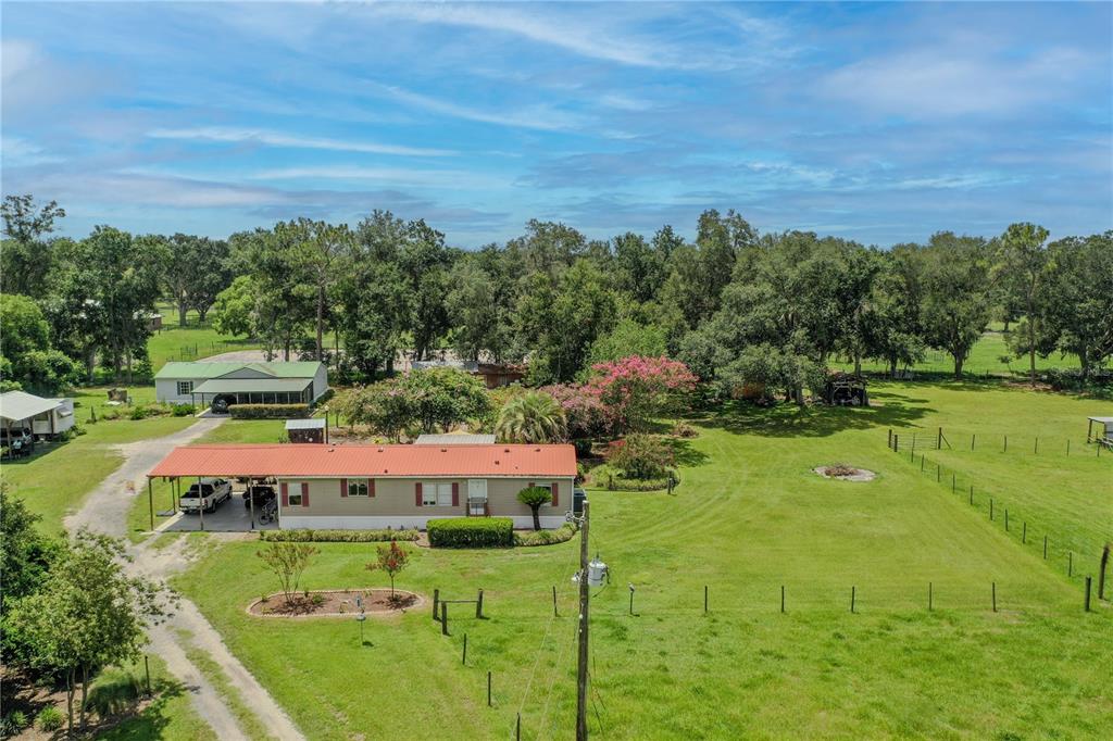 an aerial view of a house with garden space and street view