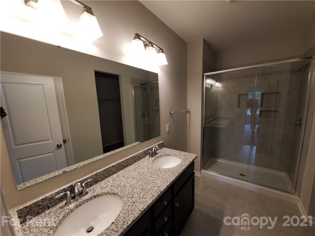 8633 River Ridge Drive Charlotte, NC 28213 - Photo 11 of 23 a bathroom with a granite countertop sink mirror and shower