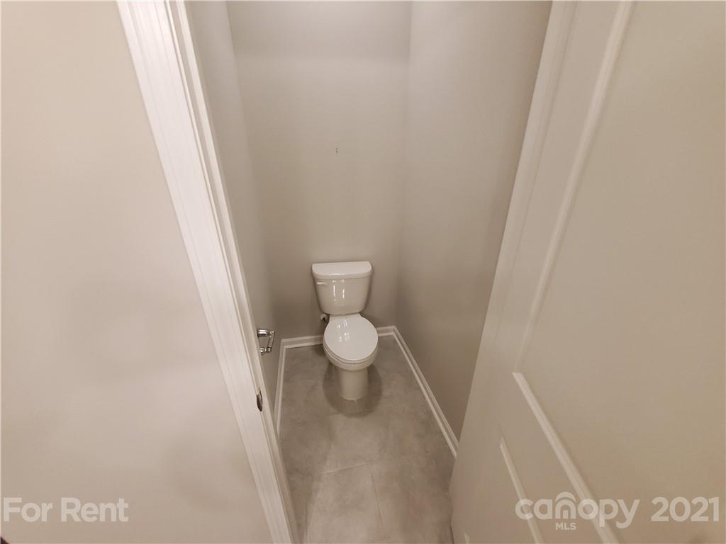 8633 River Ridge Drive Charlotte, NC 28213 - Photo 12 of 23 a white toilet sitting next to a white wall