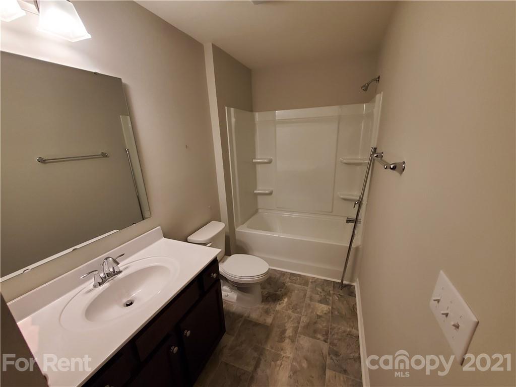 8633 River Ridge Drive Charlotte, NC 28213 - Photo 22 of 23 a bathroom with a sink a toilet and shower