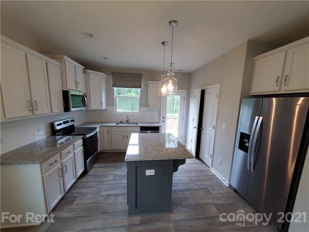 8633 River Ridge Drive Charlotte, NC 28213 - Photo 7 of 23 a kitchen with stainless steel appliances granite countertop a refrigerator a sink dishwasher a stove top oven a refrigerator and cabinets