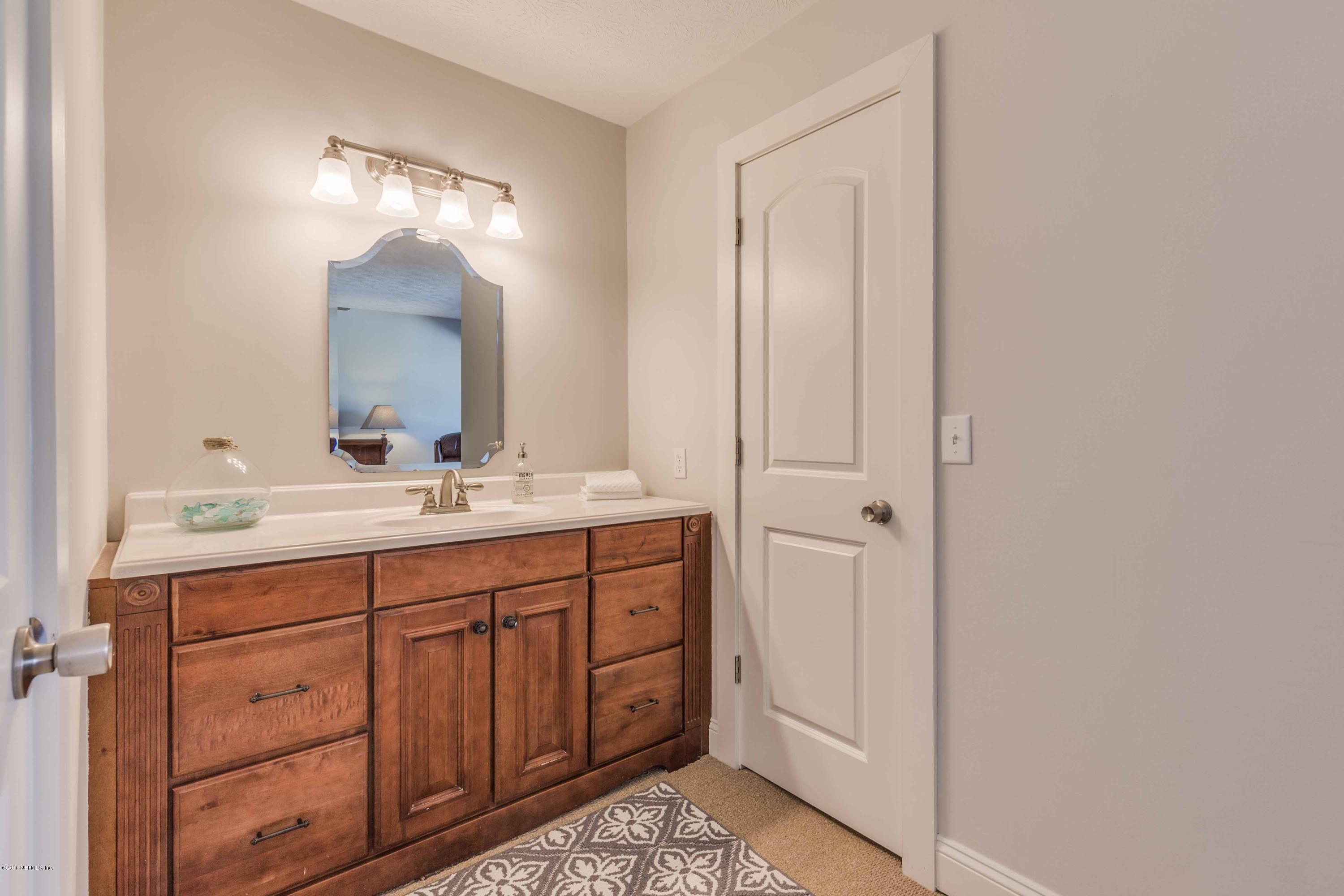 1755 Seminole Road Atlantic Beach, FL 32233 - Photo 14 of 28 a bathroom with a double vanity sink and mirror