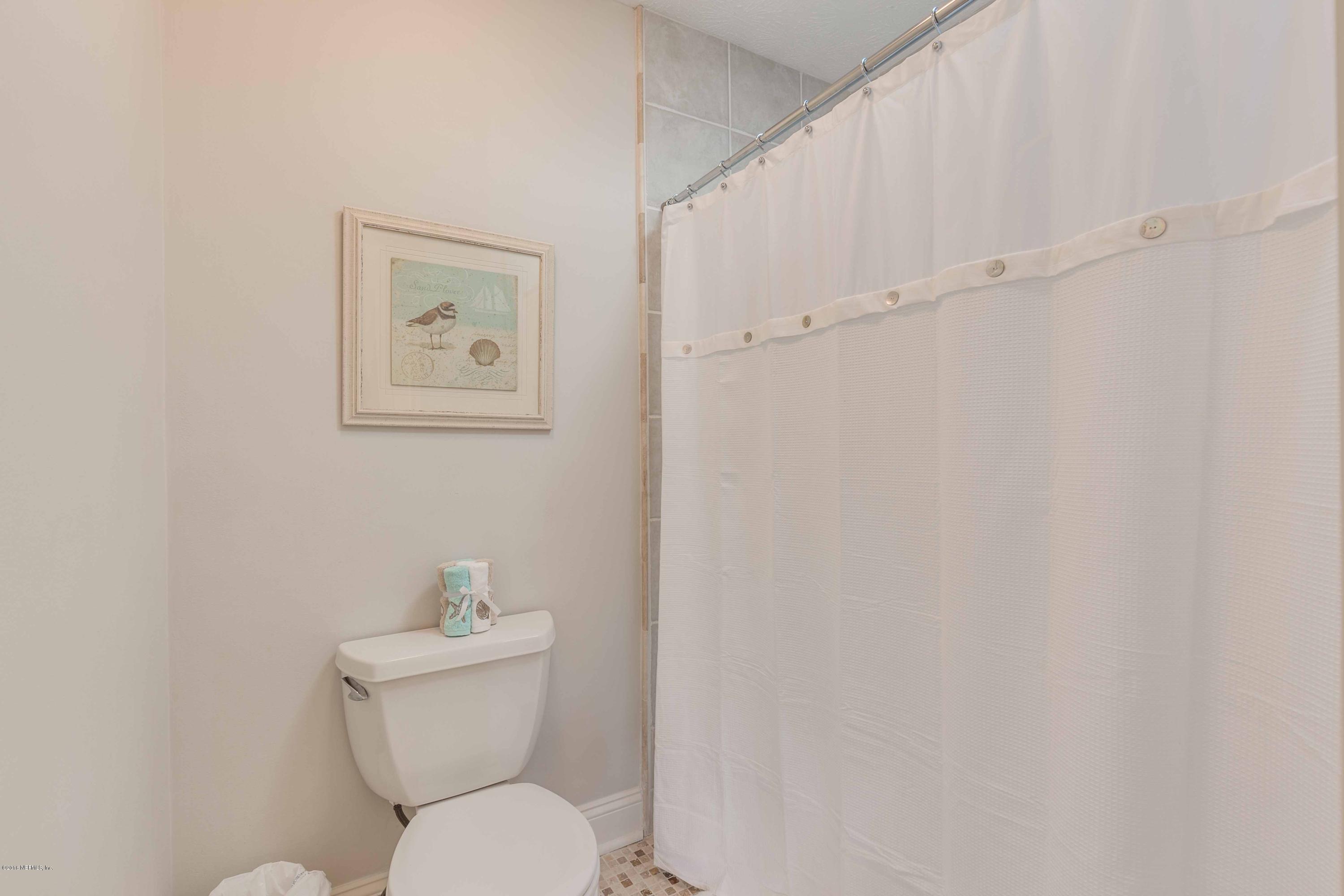 1755 Seminole Road Atlantic Beach, FL 32233 - Photo 15 of 28 a white toilet sitting next to a bathroom sink