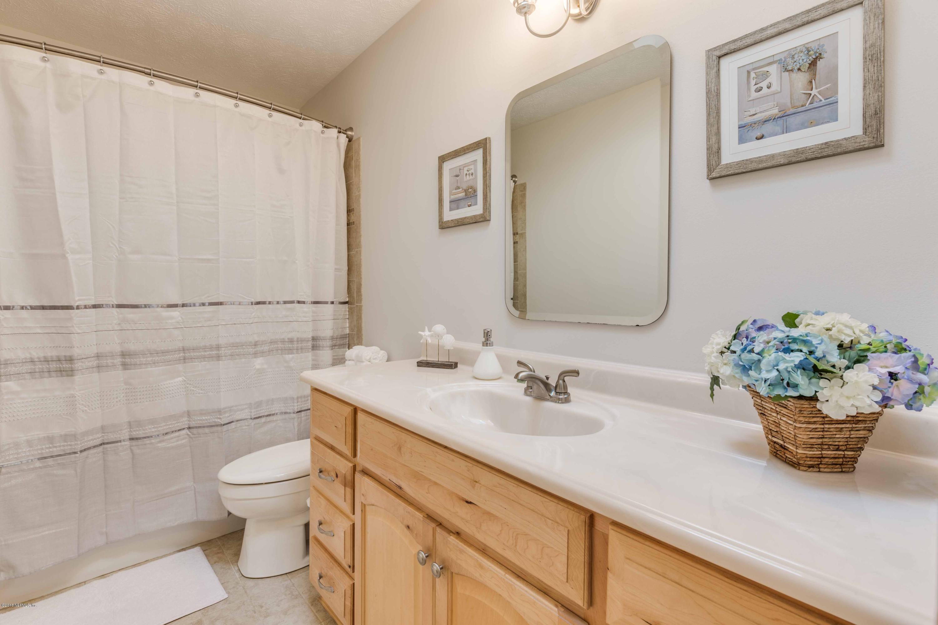 1755 Seminole Road Atlantic Beach, FL 32233 - Photo 18 of 28 a bathroom with a toilet a sink and mirror