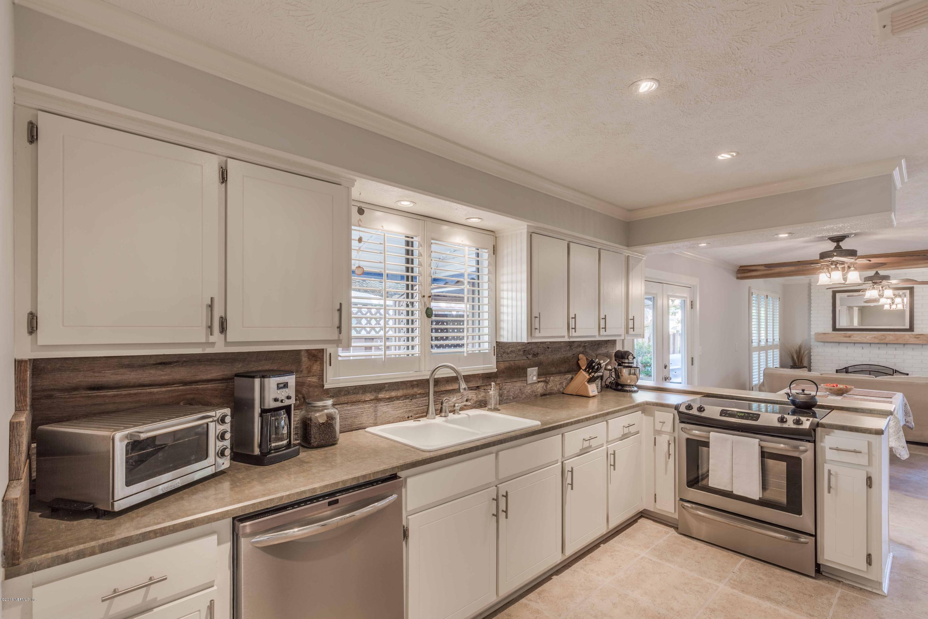 1755 Seminole Road Atlantic Beach, FL 32233 - Photo 4 of 28 a kitchen with sink cabinets and window