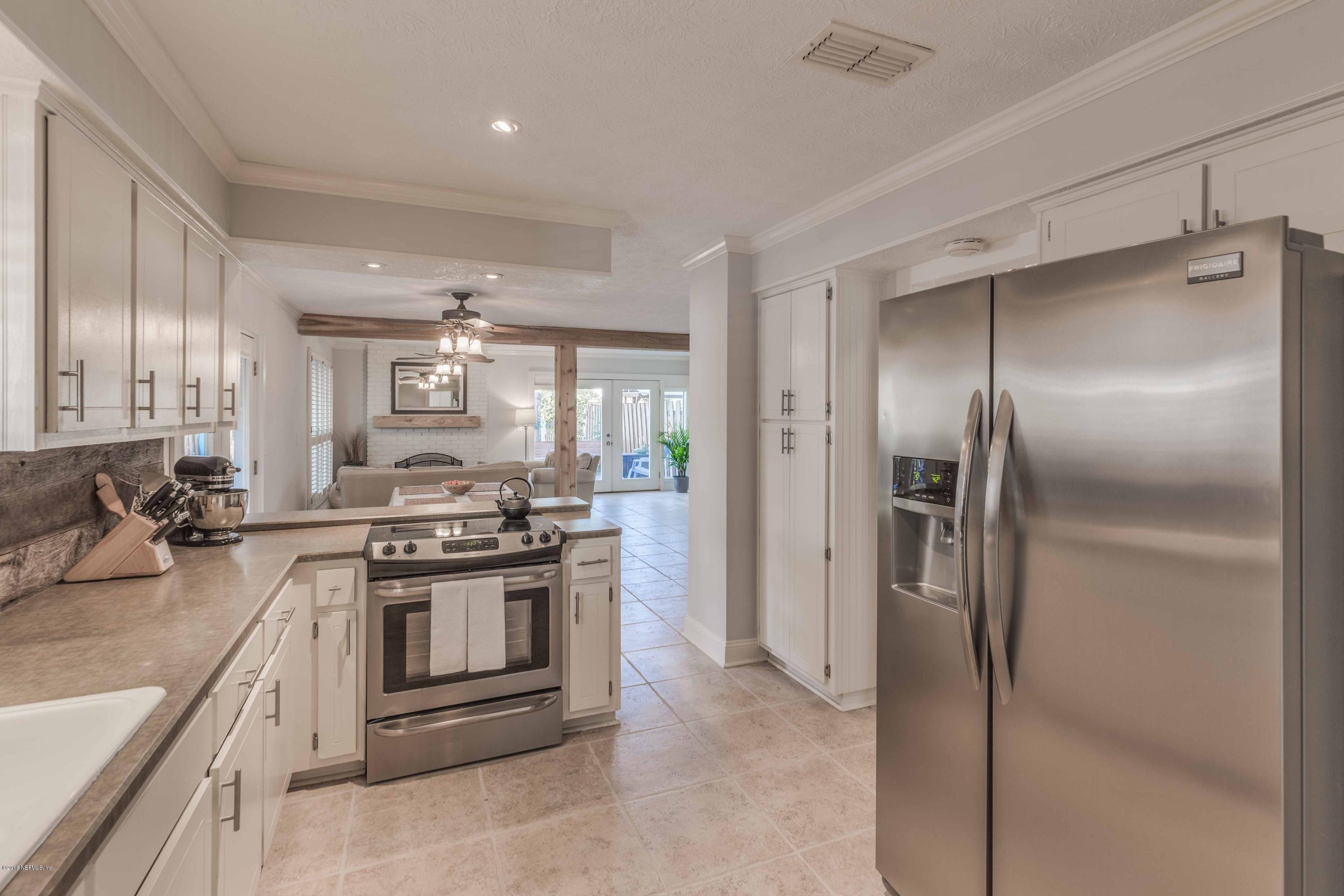 1755 Seminole Road Atlantic Beach, FL 32233 - Photo 6 of 28 a kitchen with stainless steel appliances granite countertop a stove a refrigerator and a sink