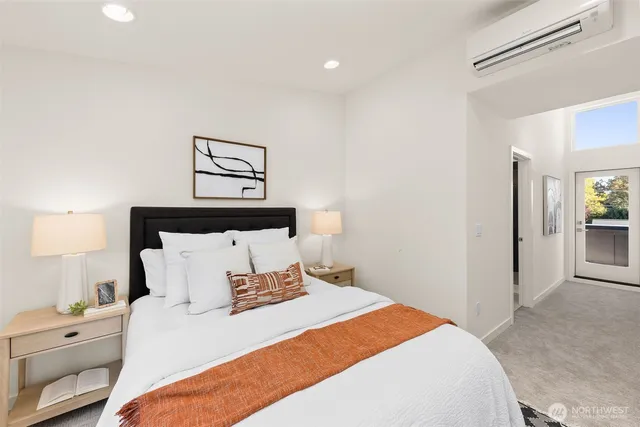 a bedroom with a bed and painting on the wall