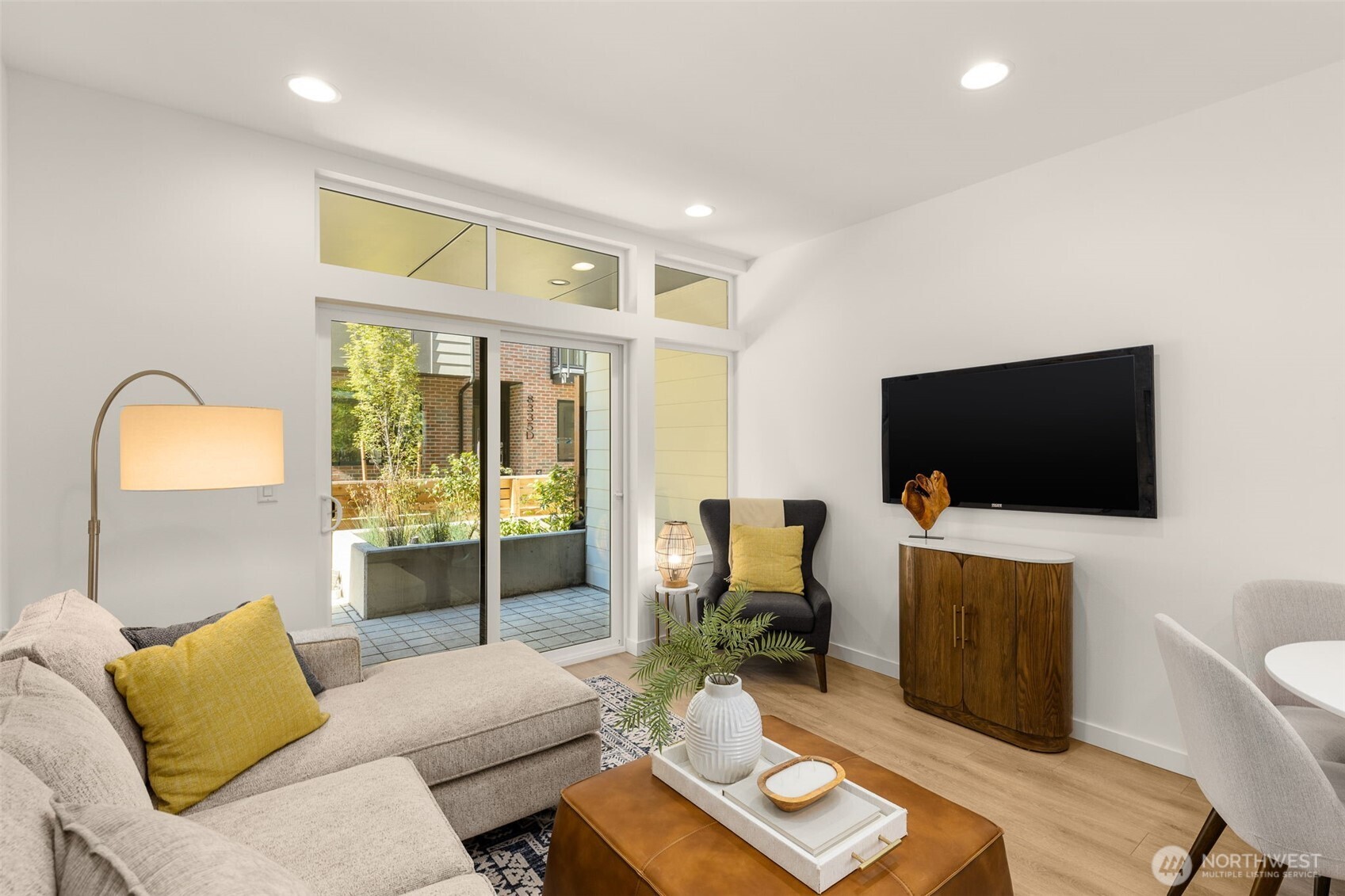 8333 C 12th Avenue Northwest Seattle, WA 98117 - Photo 6 of 24 a living room with furniture and a flat screen tv