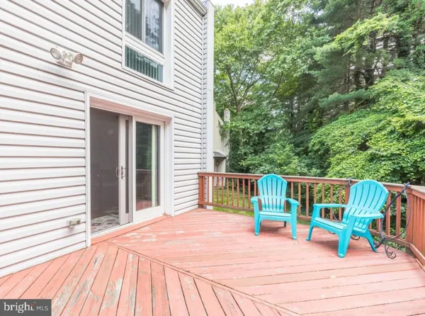 a view of a deck with chairs a barbeque with wooden floor and fence