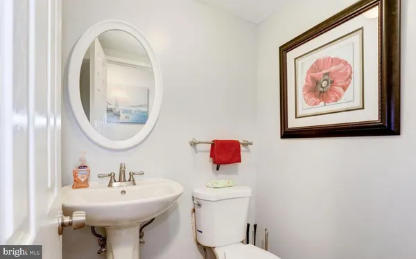 a bathroom with a toilet a sink and a mirror