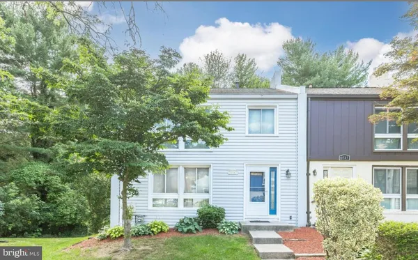 a house that has a tree in front of it